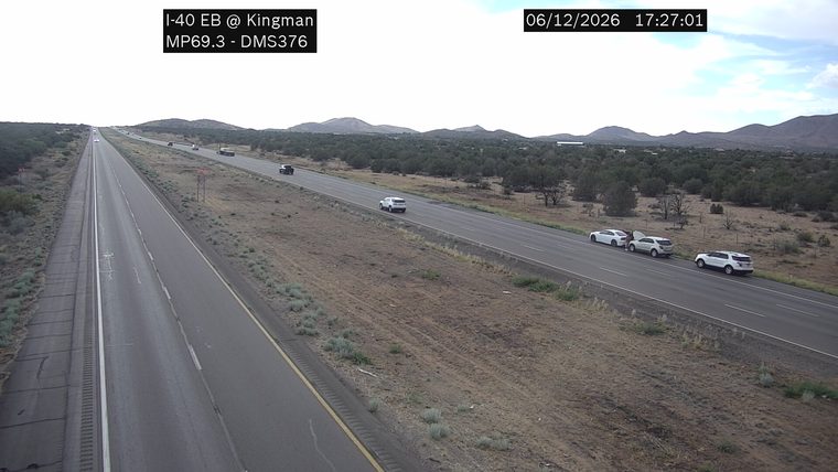Three vehicles on the right shoulder, one with hood up