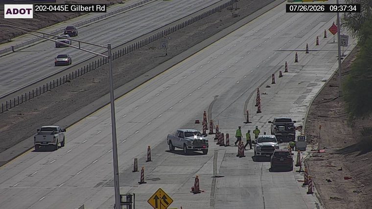 Construction cones and workers in the right lane