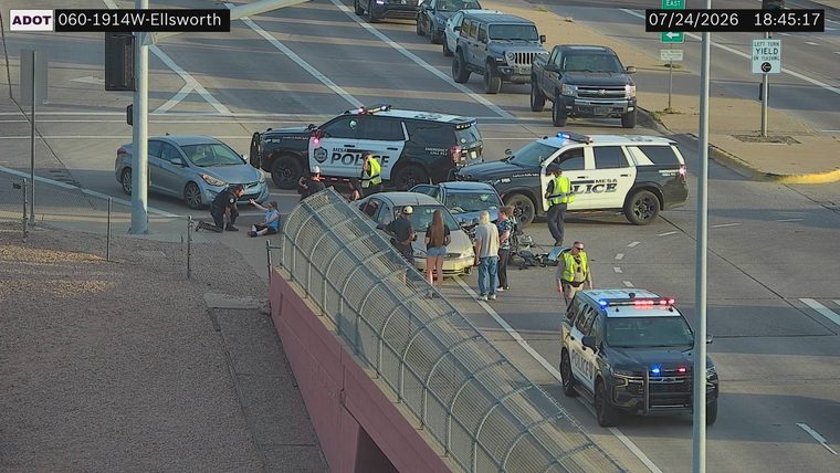 Two vehicles collided in the roadway with visible damage, police responders present