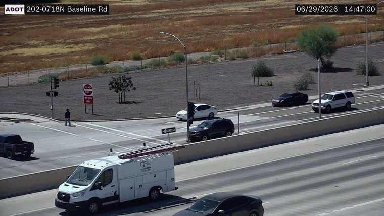 Person standing near 'Do Not Enter Wrong Way' sign
