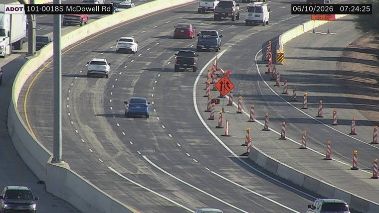 Construction cones and a sign indicating lane closure in the right lane