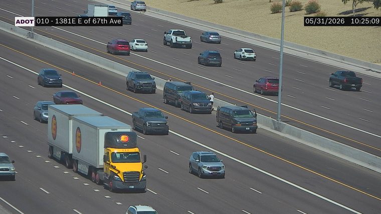 Police SUV and two individuals on the right shoulder