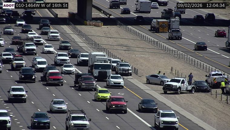 Tow truck assisting a damaged car on the right shoulder