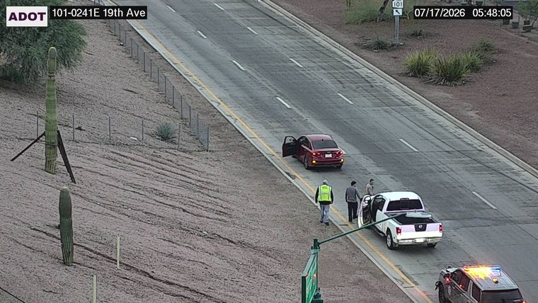 Police car with red and blue lights on the right shoulder