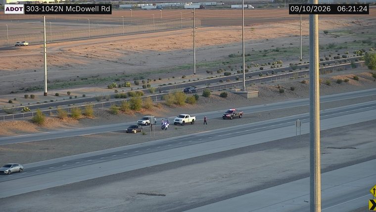 Police car with emergency lights on the right shoulder