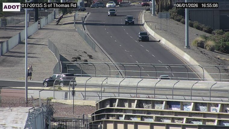 Person walking on the left side of the roadway
