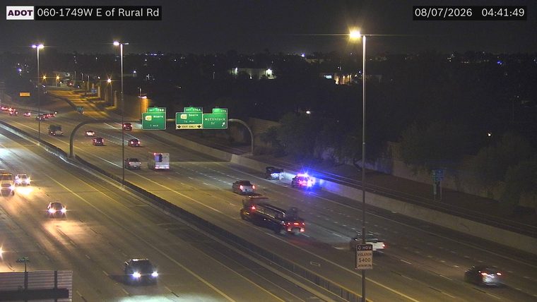 Police car with blue and red lights on the right shoulder