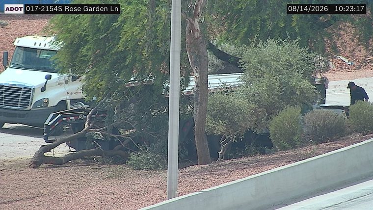 ADOT vehicle and a red truck with visible damage in the median area