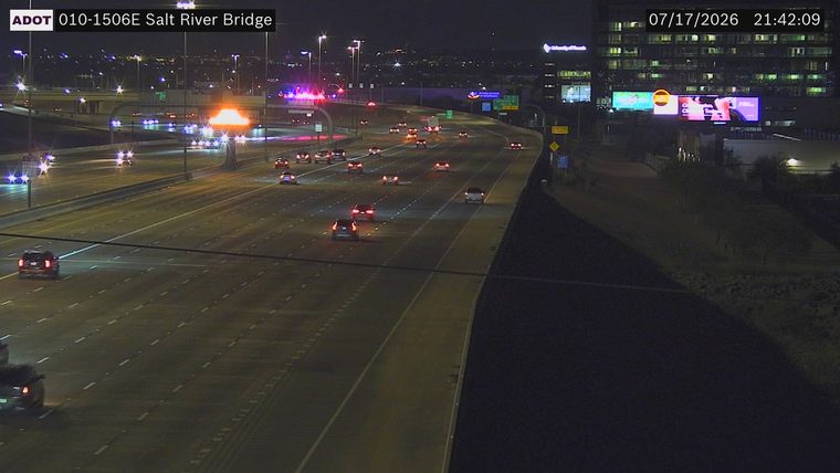 Police car with red and blue lights on the left shoulder