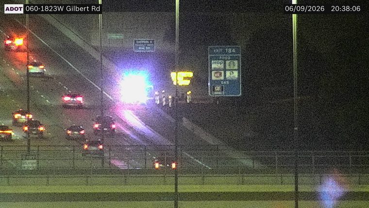 Multiple responders and emergency lights in the left lane