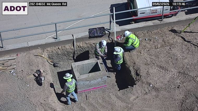 Construction workers and equipment in the roadway