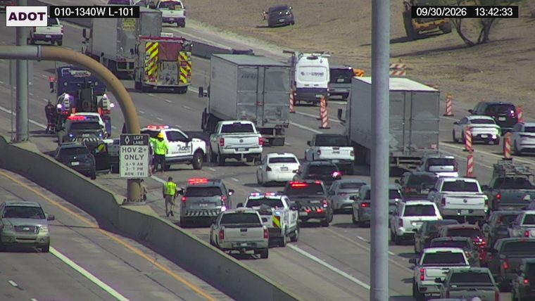 Multiple police vehicles and a fire truck with emergency lights on the left shoulder