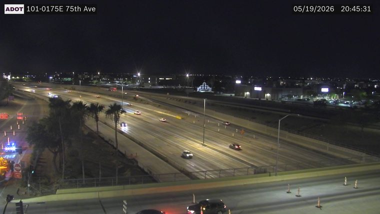 Police car with flashing blue lights on the left ramp shoulder