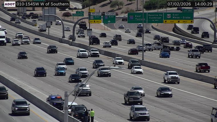 Police car with red and blue lights on the right shoulder