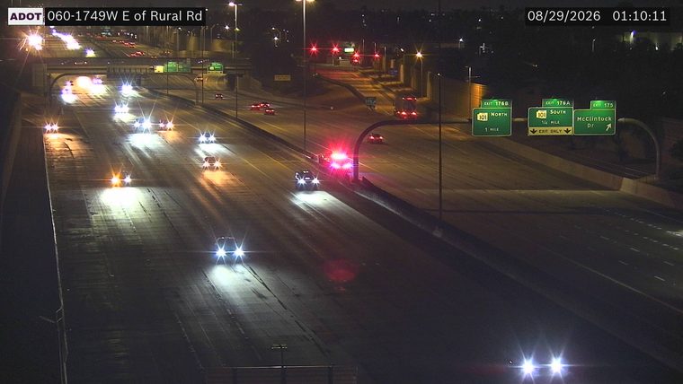 Police car with red and blue lights on the right shoulder