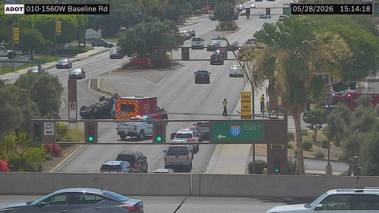 Overturned vehicle in the left lane with an ambulance and fire truck present