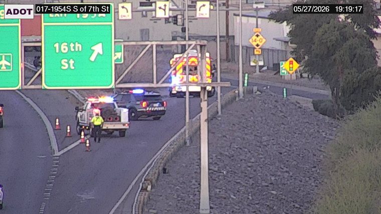 ADOT truck, police vehicle, and fire truck with flashing lights on the exit ramp, with a responder standing near cones