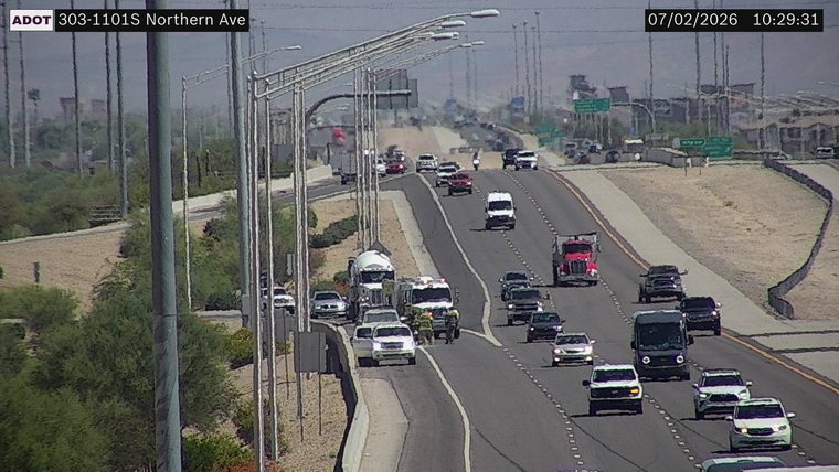 Fire truck with lights on in the right lane