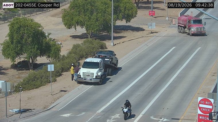 Tow truck with a vehicle on its flatbed on the right shoulder