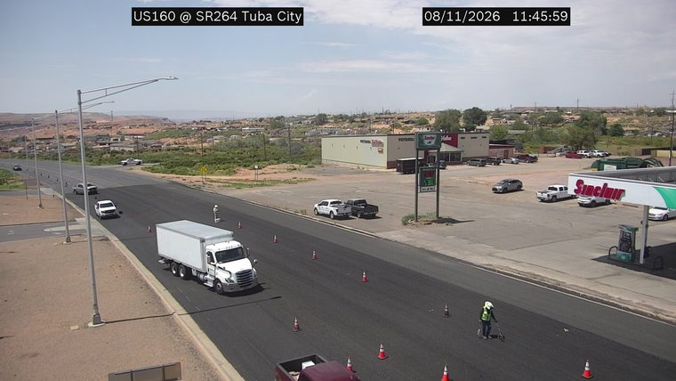 Construction cones and a worker in the right lane