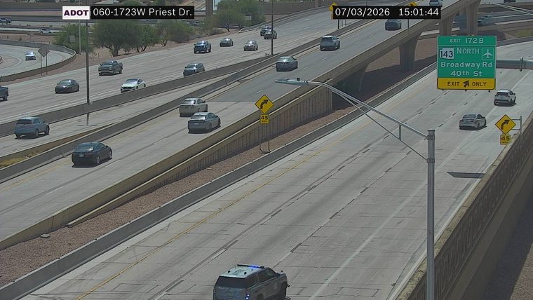 Police SUV with blue and red lights on the right shoulder