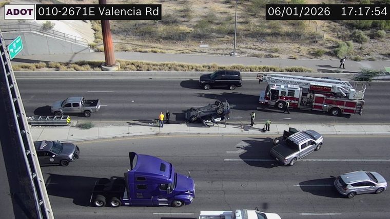 Overturned vehicle with responders present in the left lane