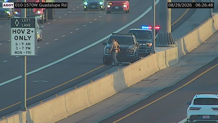 Police car with red and blue lights on the shoulder