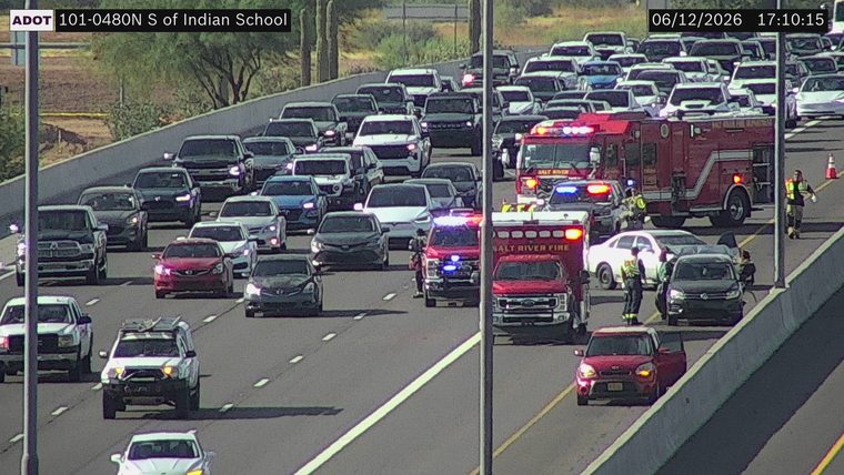 Fire truck and ambulance with emergency personnel on the roadway