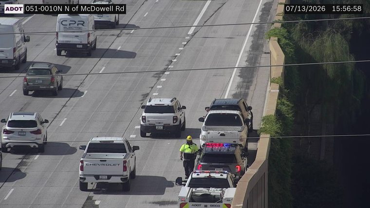 Police car with red and blue lights on the right shoulder