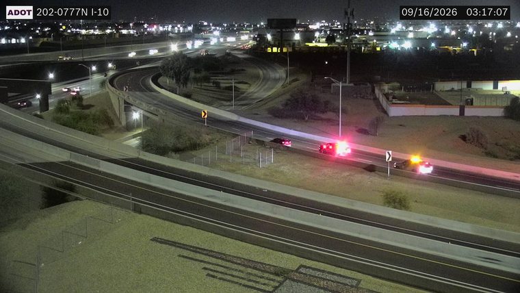 Two vehicles with emergency lights on the right shoulder