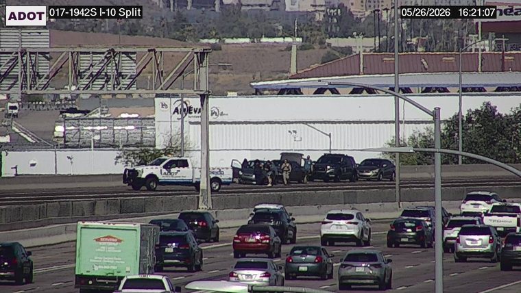 ADOT Incident Response truck and multiple vehicles stopped on the shoulder with doors open and people standing