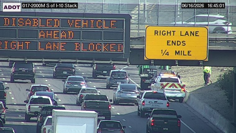 Tow truck and a worker on the right shoulder