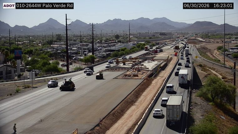 Construction activity with workers and equipment in the right lanes