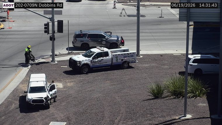 State Trooper vehicle with visible damage and an ADOT Incident Response truck on the roadway