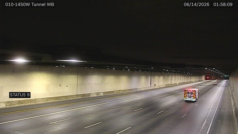 Ambulance with flashing lights in the right lane