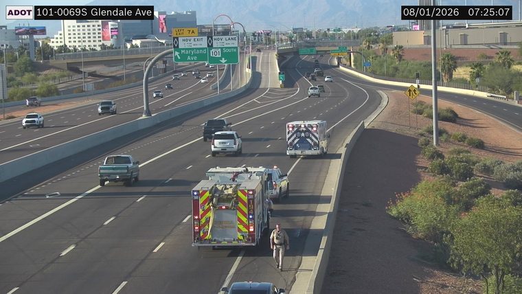 Fire truck and ambulance with a person walking on the shoulder