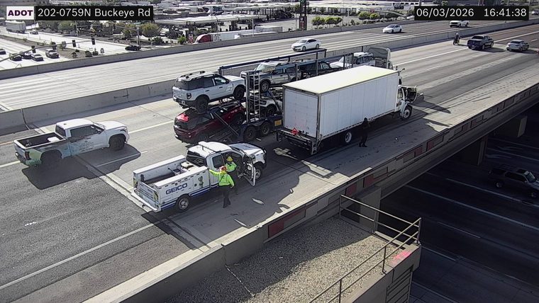 Two workers in the left lane near a white truck