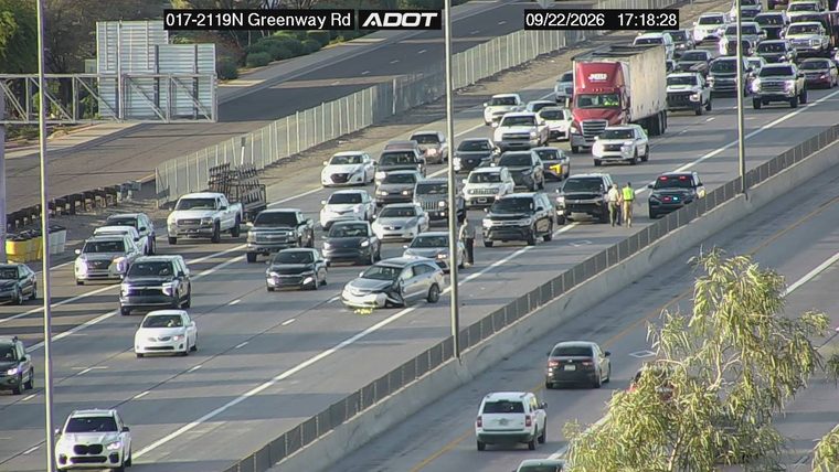 Silver sedan with visible damage in the left lane