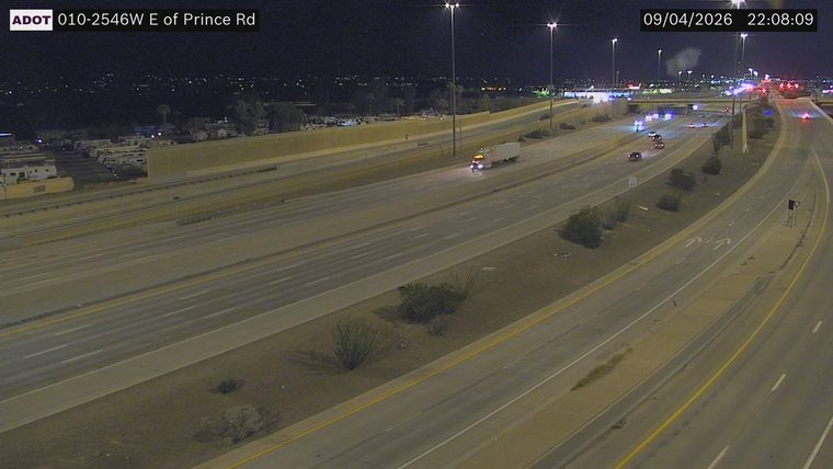 Multiple vehicles with red and blue flashing lights in the right lanes