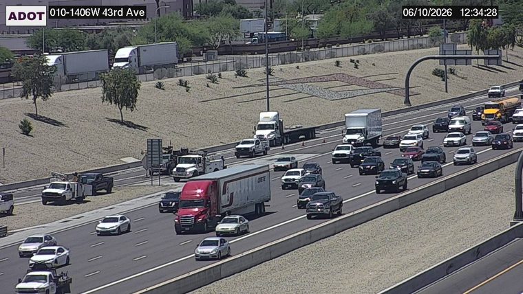 Construction cones and workers in the left lane