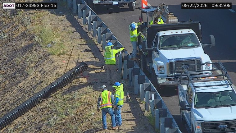 Workers and equipment on the right shoulder and in the right lane