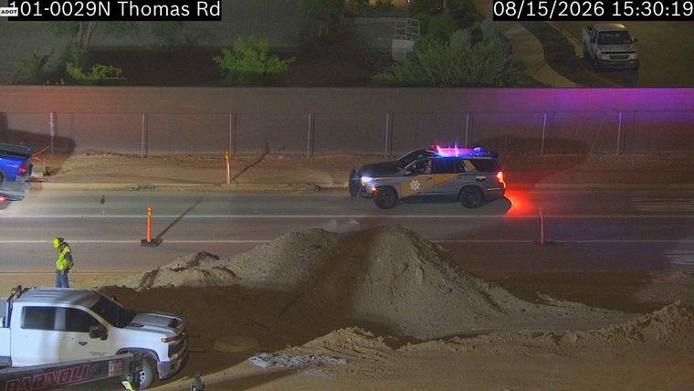 Police car with red and blue lights on the roadway