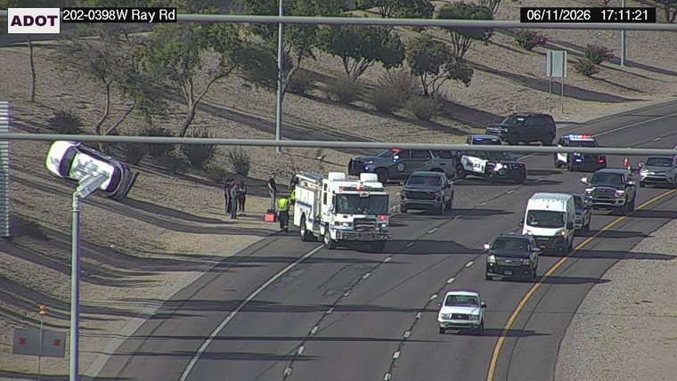 Fire truck and multiple police cars with emergency lights on in the right lane