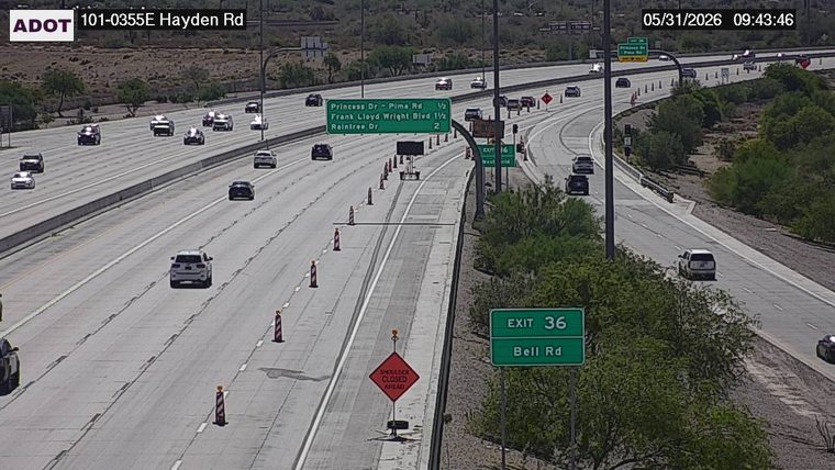 Construction cones and a 'shoulder closed ahead' sign in the right lane