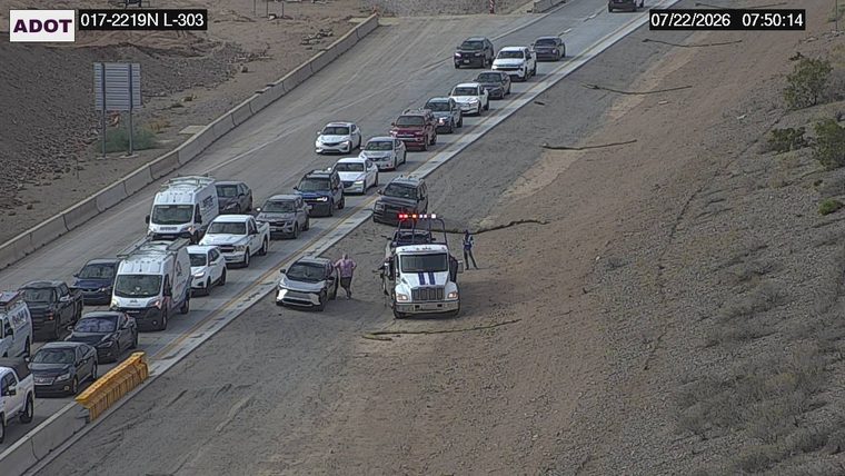 Tow truck assisting a car on the right shoulder