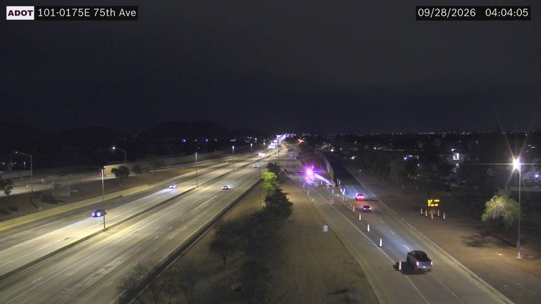 Police car with red and blue lights on the right shoulder