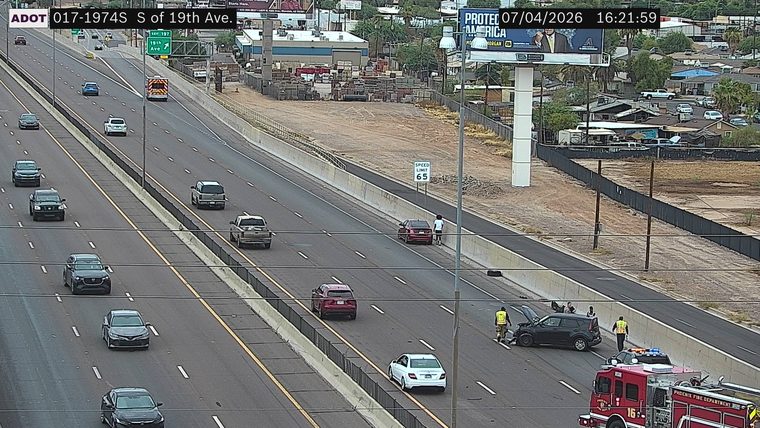 Crash with two vehicles and a fire truck with lights on in the right lane