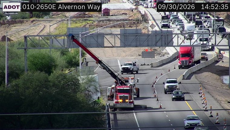 Tow truck with hazard lights on in the right lane