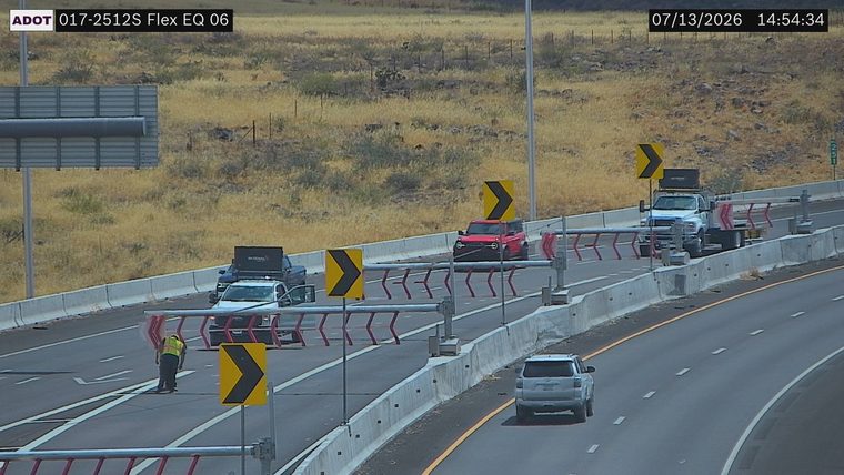 Worker in high-visibility vest in the left lane