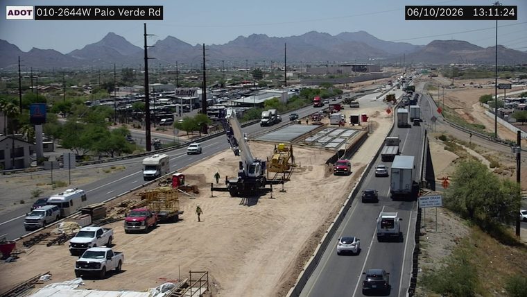 Construction activity with a crane and workers in the median area